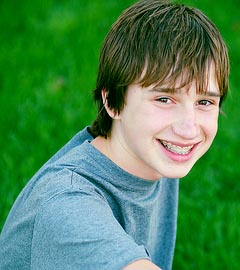 photo of a smiling teenage boy wearing braces