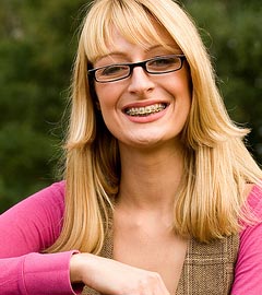 photo of a smiling adult woman wearing braces