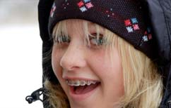 photo of a smiling teenager wearing braces