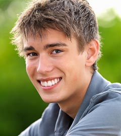photo of a smiling teenage boy undergoing orthodontic treatment